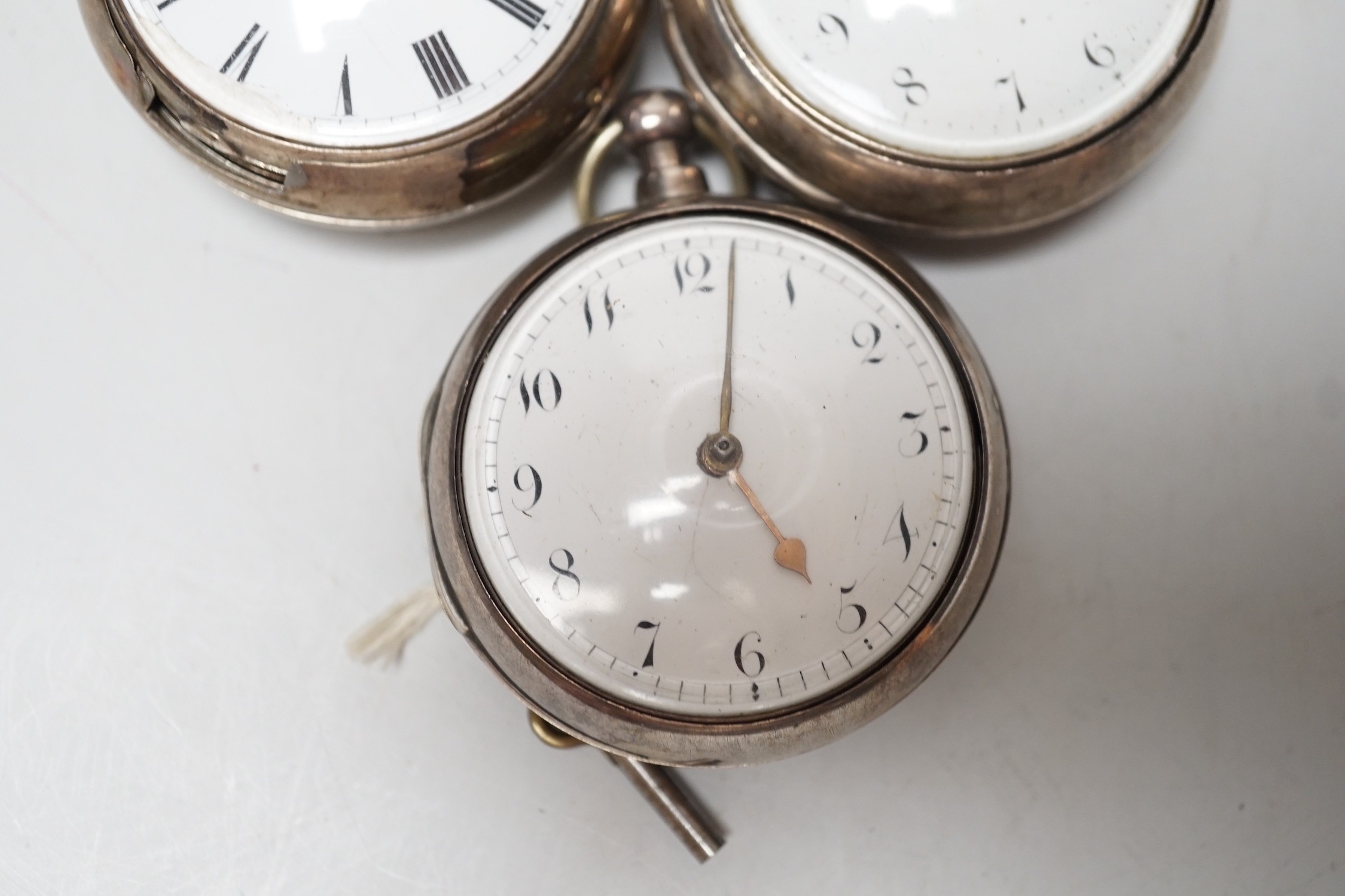 Three 19th century silver pair cased keywind verge pocket watches, by Graham, London, one signed WG, the other unsigned.